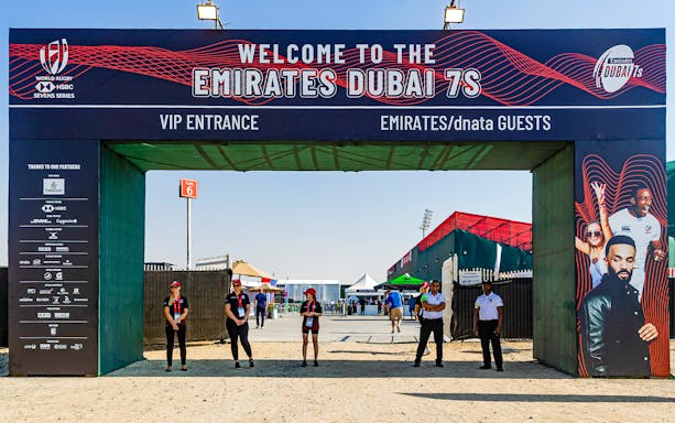 Entrance to Emirates Dubai 7s with staff and event signage, Gate 6 in background.