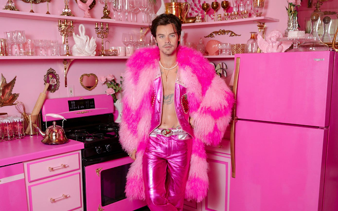 Guests exploring celebrity wax figure in pink-themed room at Madame Tussauds Nashville.