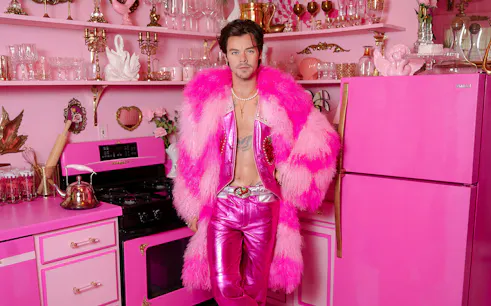 Guests exploring celebrity wax figure in pink-themed room at Madame Tussauds Nashville.