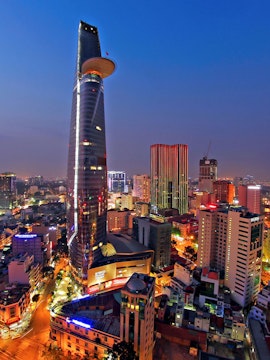 Saigon Skydeck nightscape view of Ho Chi Minh City skyline with illuminated skyscrapers and bustling streets.