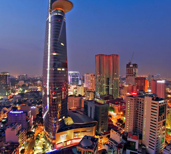 Saigon Skydeck nightscape view of Ho Chi Minh City skyline with illuminated skyscrapers and bustling streets.