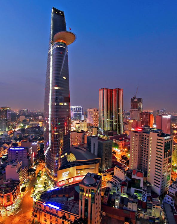 Saigon Skydeck nightscape view of Ho Chi Minh City skyline with illuminated skyscrapers and bustling streets.