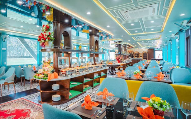 Dining area on Apollo Cruise 2 with buffet setup and elegant table settings.