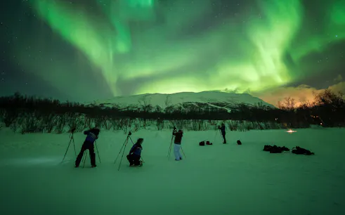 Photographers capturing Northern Lights in Abisko, Sweden.