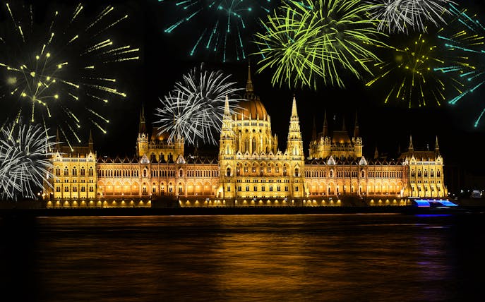 Budapest Parliament lit up with fireworks during a dinner cruise on the Danube River.