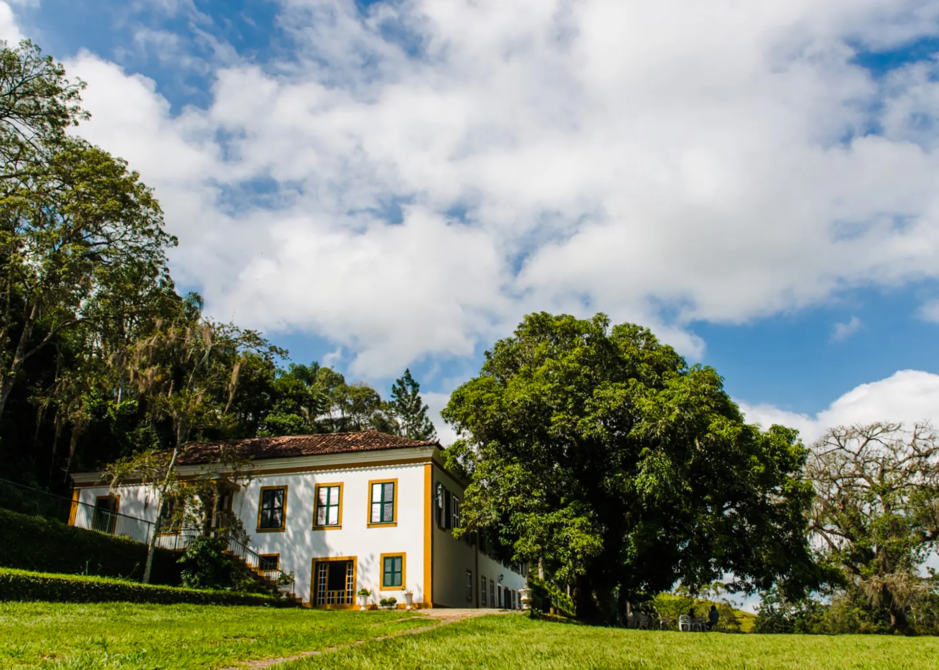 Historic plantation house surrounded by lush greenery in Coffee Valley, Rio de Janeiro.