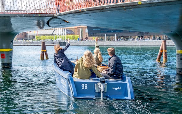 GoBoat tour in Copenhagen harbor with guests passing city landmarks.