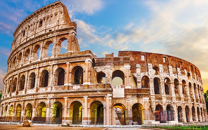 Colosseum in Rome under a blue sky, part of skip-the-line tour package.