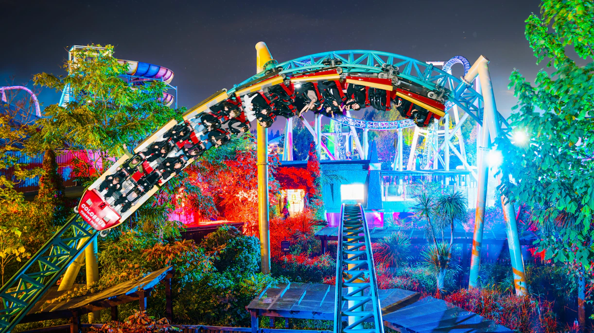 Roller coaster at night during Thorpe Park Fright Nights, illuminated with colorful lights.