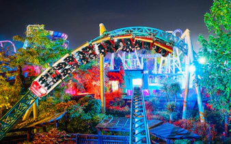 Roller coaster at night during Thorpe Park Fright Nights, illuminated with colorful lights.