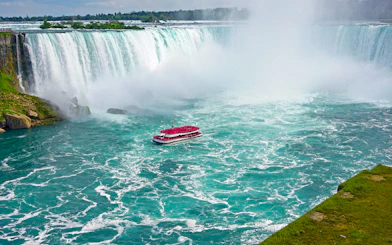 Aerial view of Niagara Falls with tour boat in the water.