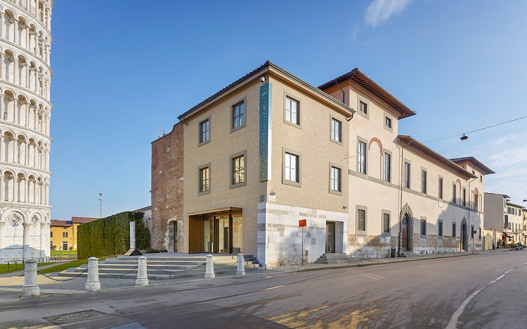 Opera del Duomo Museum exterior in Pisa with Leaning Tower visible nearby.