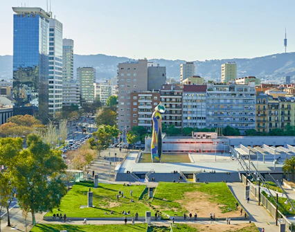 Barcelona skyline with Joan Miró Square and sculpture in foreground.
