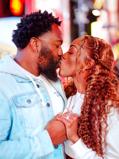 Couple kissing at Times Square, New York City.