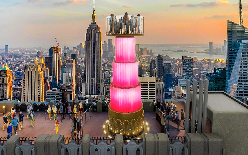 Visitors at Top of the Rock Observation Deck with Empire State Building view.