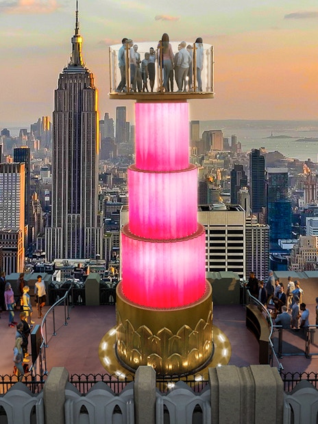 Visitors at Top of the Rock Observation Deck with Empire State Building view.