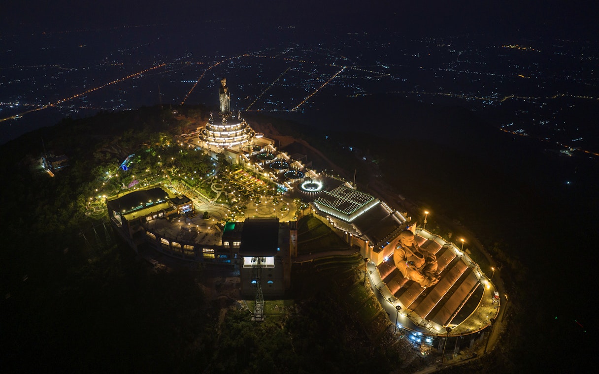 Aerial view of Sun World Ba Den Mountain at night, featuring illuminated Hang Pagoda and Van Son Peak.
