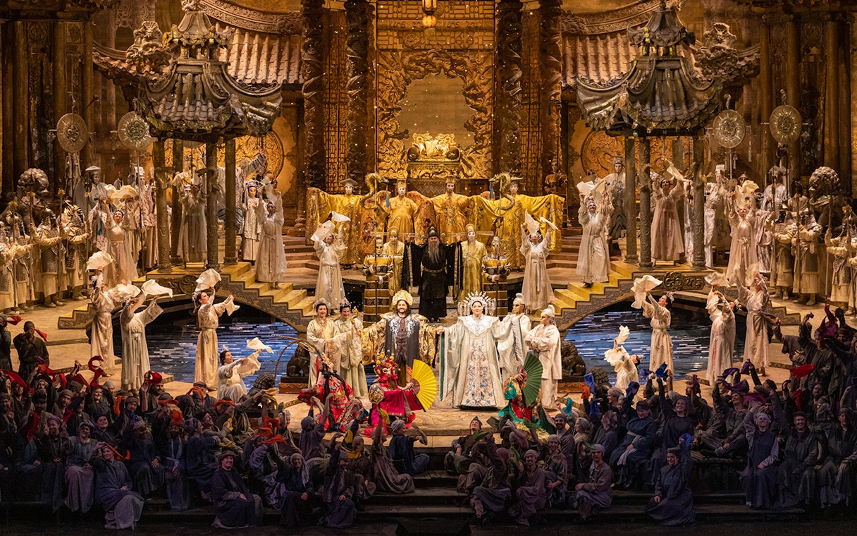 Opera performance of Turandot with elaborate costumes and grand stage set.