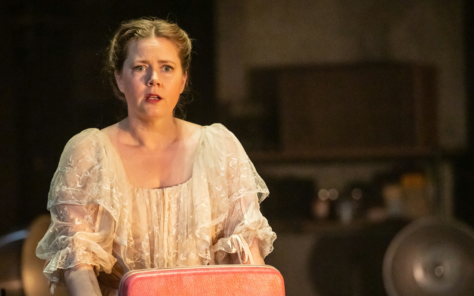 Woman in period costume performing in "The Glass Menagerie" play.