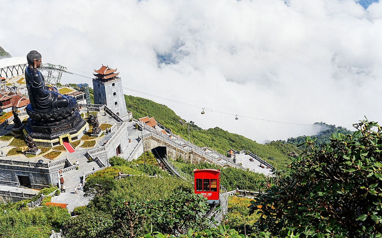 Cable car and Buddha statue at Sun World Fansipan Legend, Vietnam.