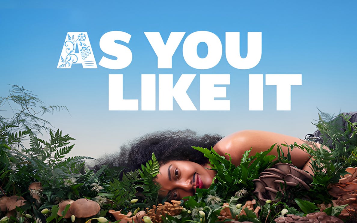 As You Like It text with person lying among greenery and mushrooms.