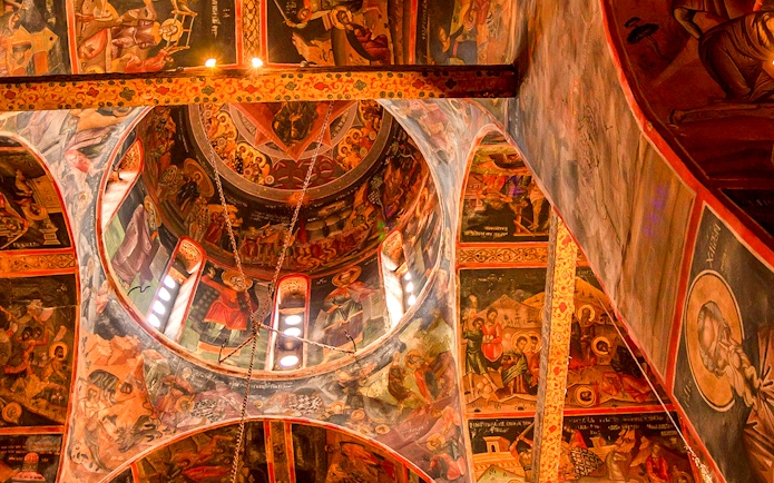 Interior frescoes of Varlaam Monastery, Greece, depicting religious scenes and figures.