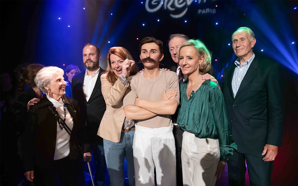 Group posing with Pierre de Coubertin wax figure at Grévin Paris.