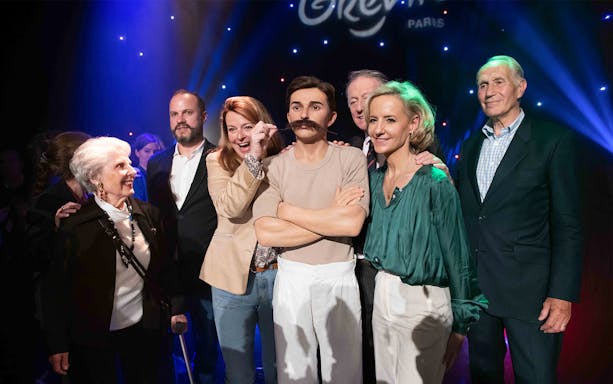 Group posing with Pierre de Coubertin wax figure at Grévin Paris.