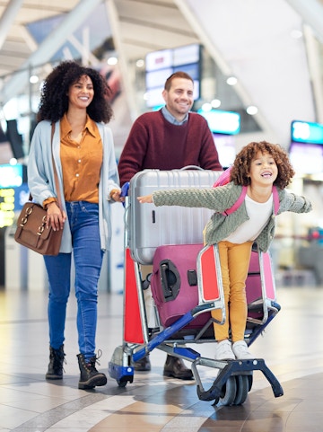 Narita International Airport terminal with travelers and check-in counters in Tokyo, Japan.