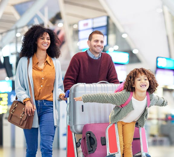 Narita International Airport terminal with travelers and check-in counters in Tokyo, Japan.