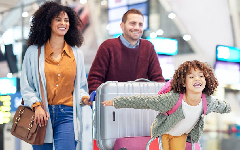Narita International Airport terminal with travelers and check-in counters in Tokyo, Japan.