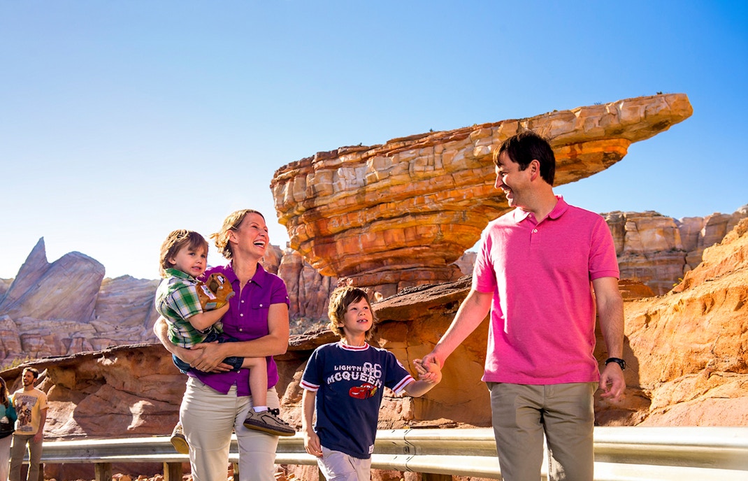 Guests enjoying Frontierland at Disneyland Park, California with rock formations in the background.