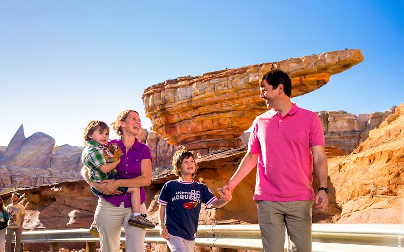 Guests enjoying Frontierland at Disneyland Park, California with rock formations in the background.