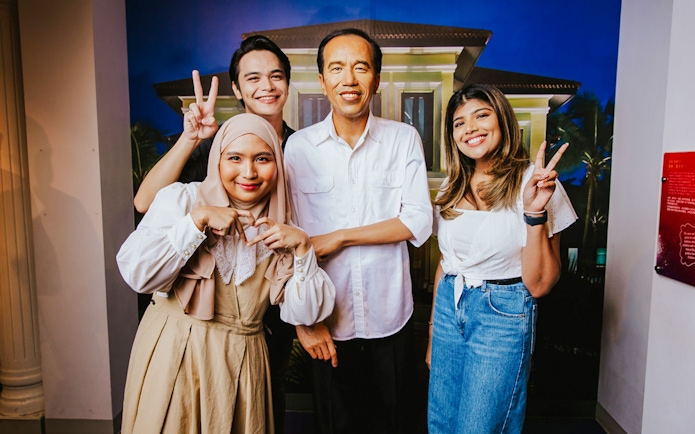 Visitors with wax figure of Joko Widodo at Madame Tussauds Singapore.