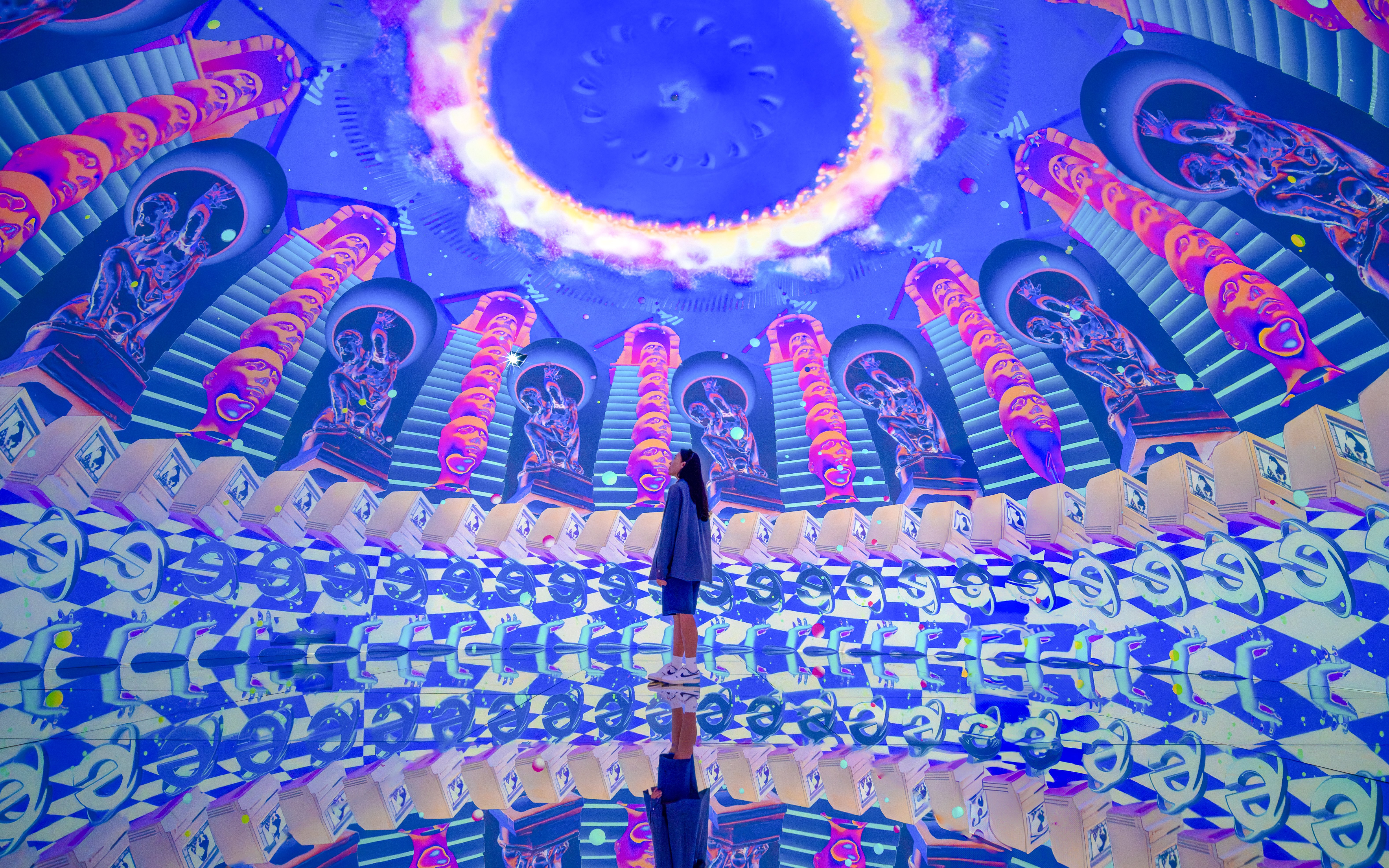 Futuristic art installation with neon colors and mirrored reflections at House Of Hype.