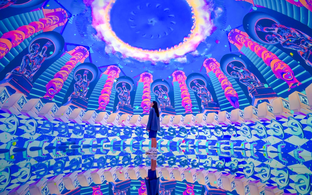 Futuristic art installation with neon colors and mirrored reflections at House Of Hype.