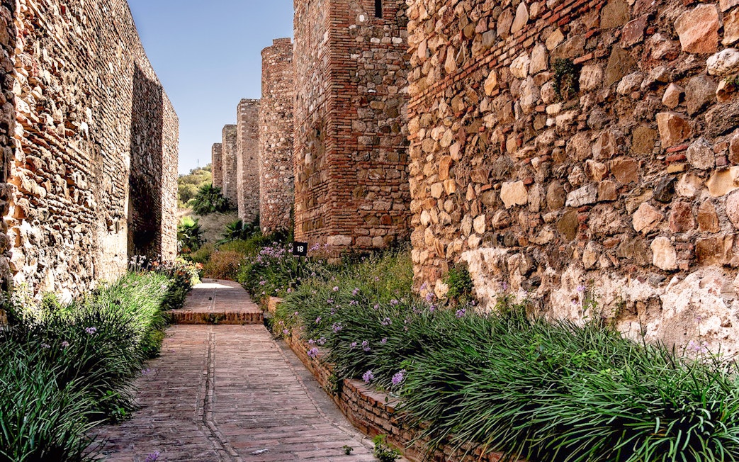 Pathway between ancient stone walls at Alcazaba in Málaga.