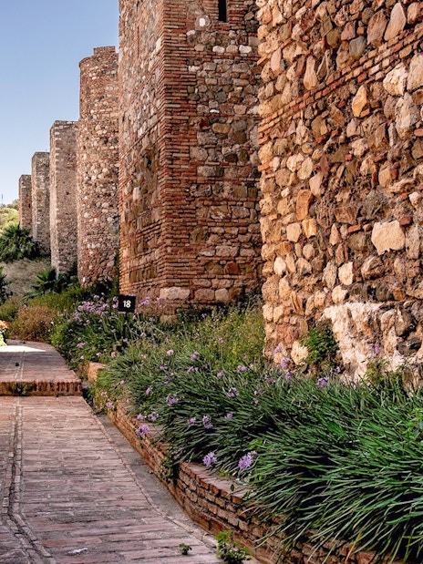 Pathway between ancient stone walls at Alcazaba in Málaga.