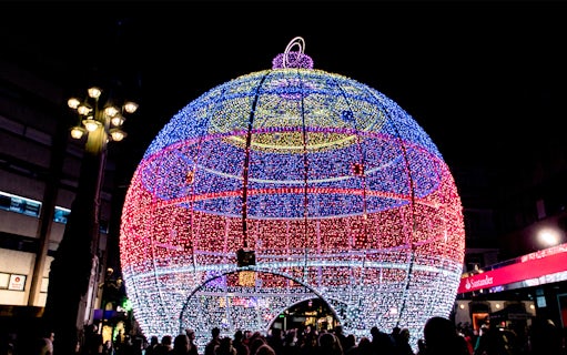 Giant illuminated Christmas ornament in Paris street.