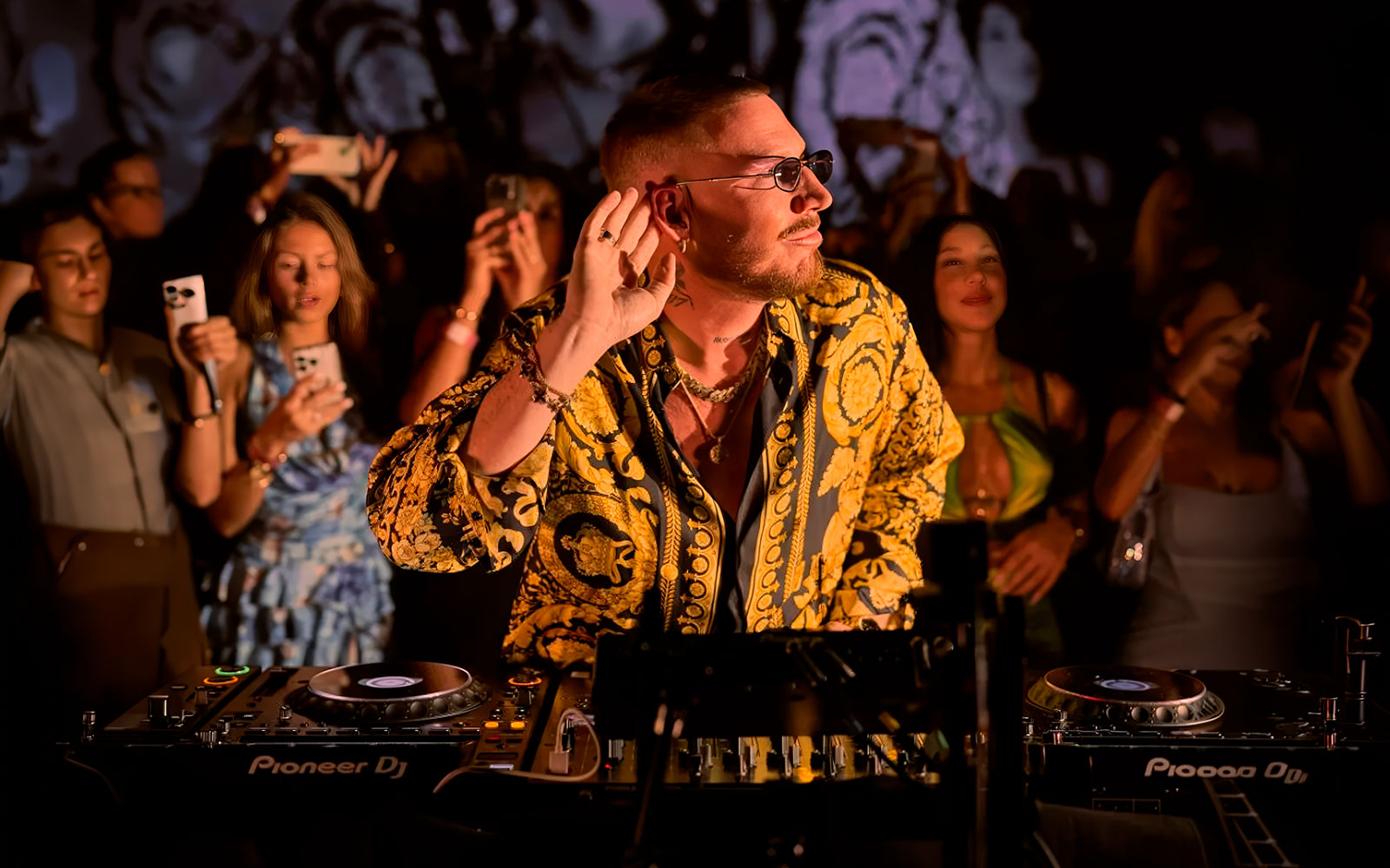 DJ performing at Make the Girls Dance event in Ibiza, surrounded by an engaged crowd.