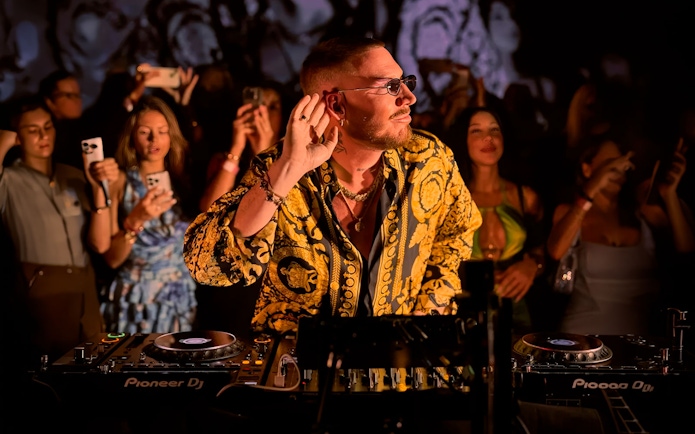 DJ performing at Make the Girls Dance event in Ibiza, surrounded by an engaged crowd.