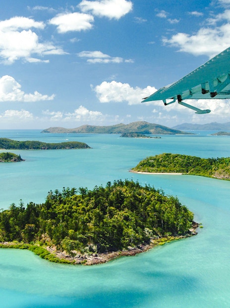 Aerial view of Heart Island in the Whitsundays with turquoise waters and lush greenery.