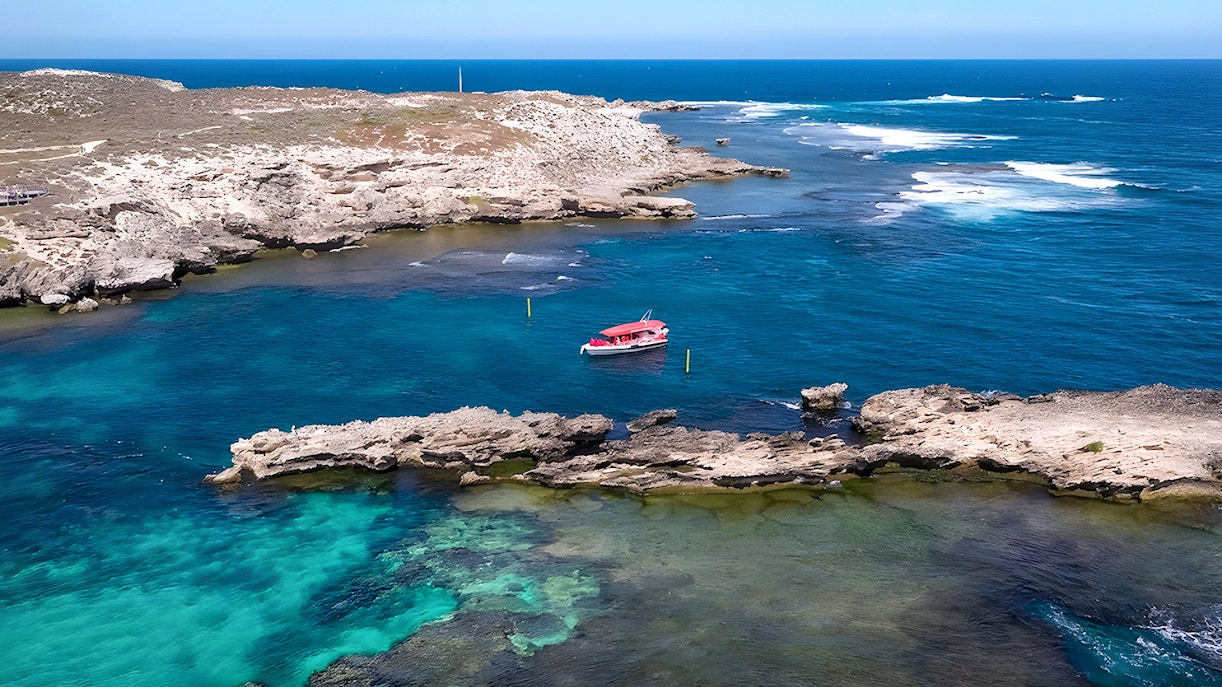 Tourists on Rottnest Island ferry with Perth skyline in background.