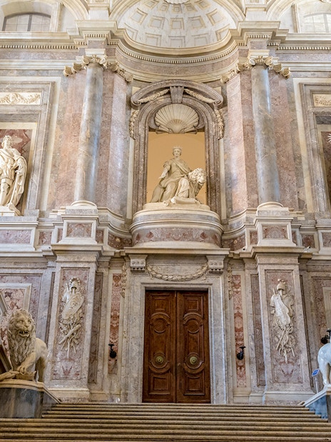 Staircase of Honour with statues and ornate architecture in the Royal Palace of Caserta.