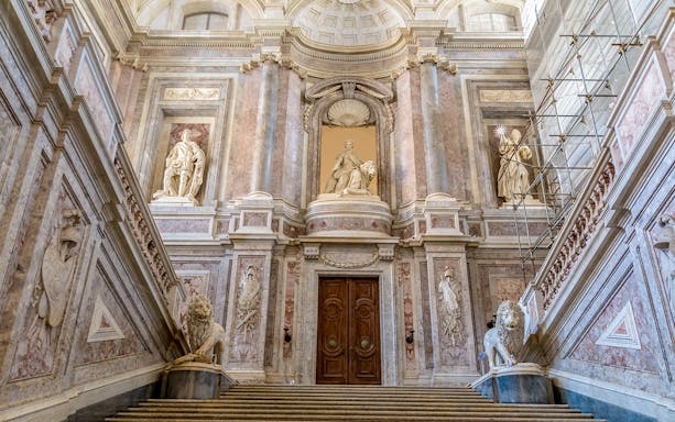 Staircase of Honour in the Royal Palace of Caserta, Italy, showcasing ornate architecture.