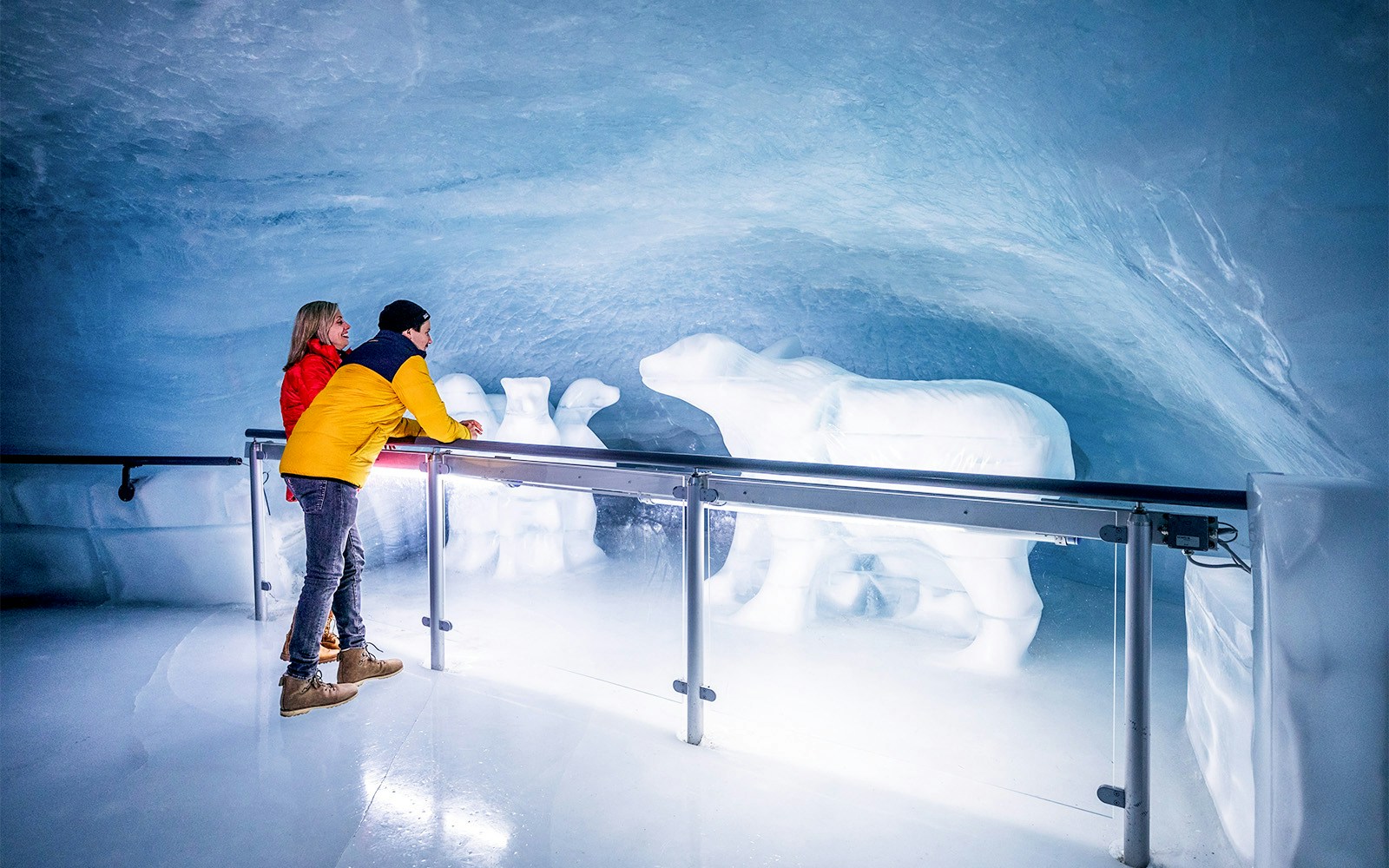 Visitors admire ice sculptures inside the Eiger Express glacier tunnel.
