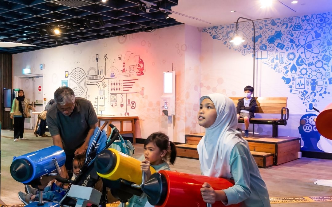 Children engaging with interactive exhibits at Petrosains, Kuala Lumpur.