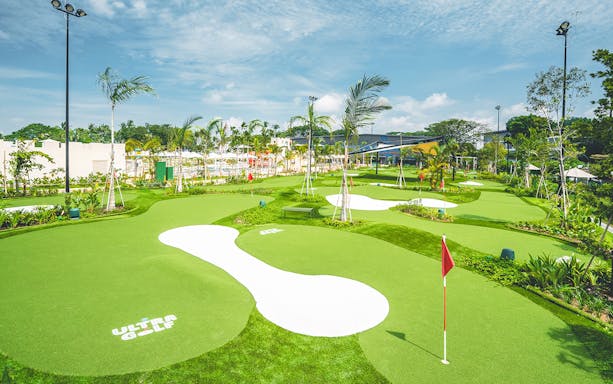 Mini-golf course with palm trees at UltraGolf, part of the Combo: HyperDrive and UltraGolf experience.