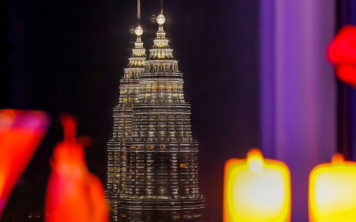 Petronas Twin Towers view from ARAS restaurant, KL Tower, Kuala Lumpur at night.