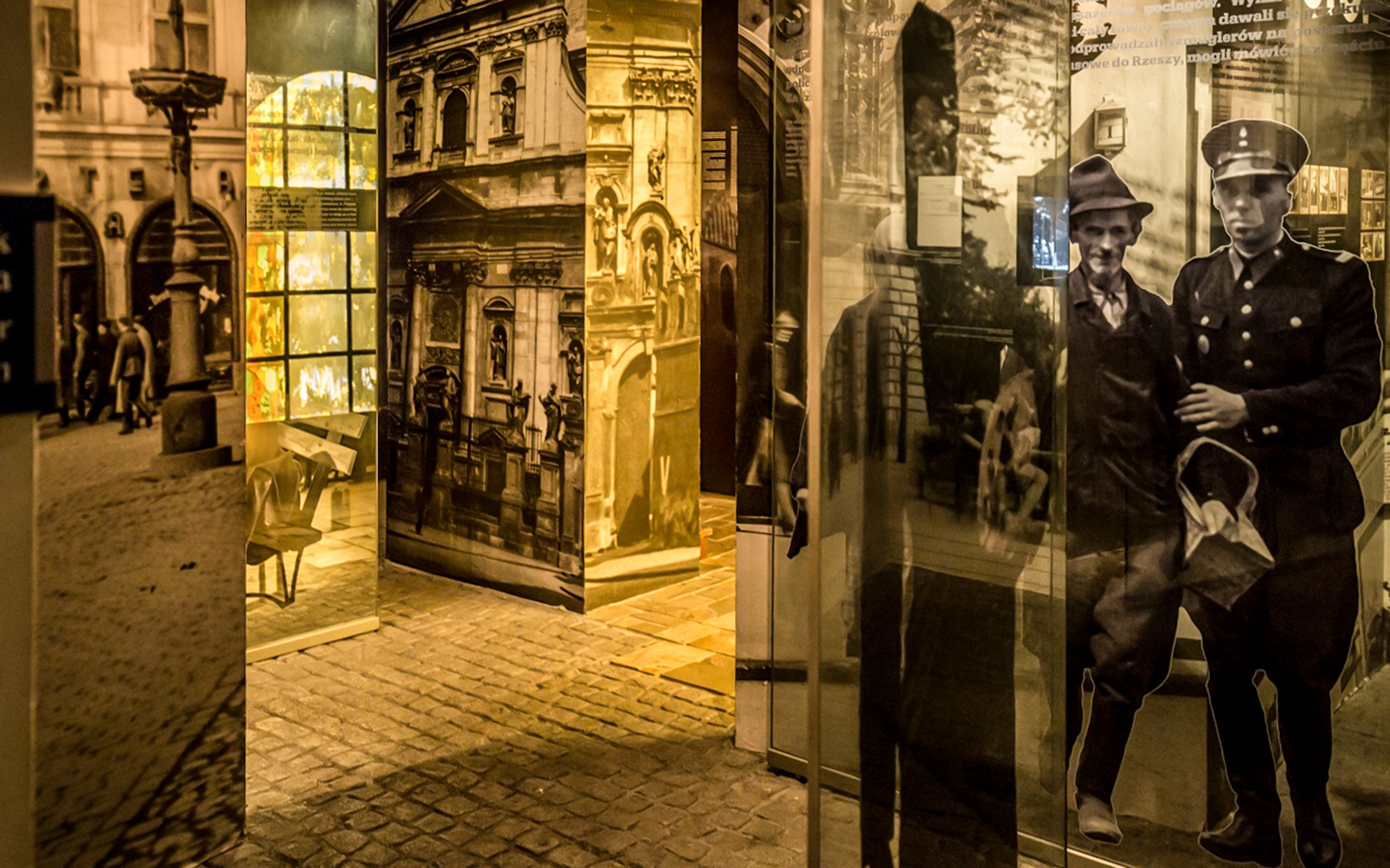 Exhibit at Schindler's Factory Museum in Krakow, showcasing historical photos and artifacts.